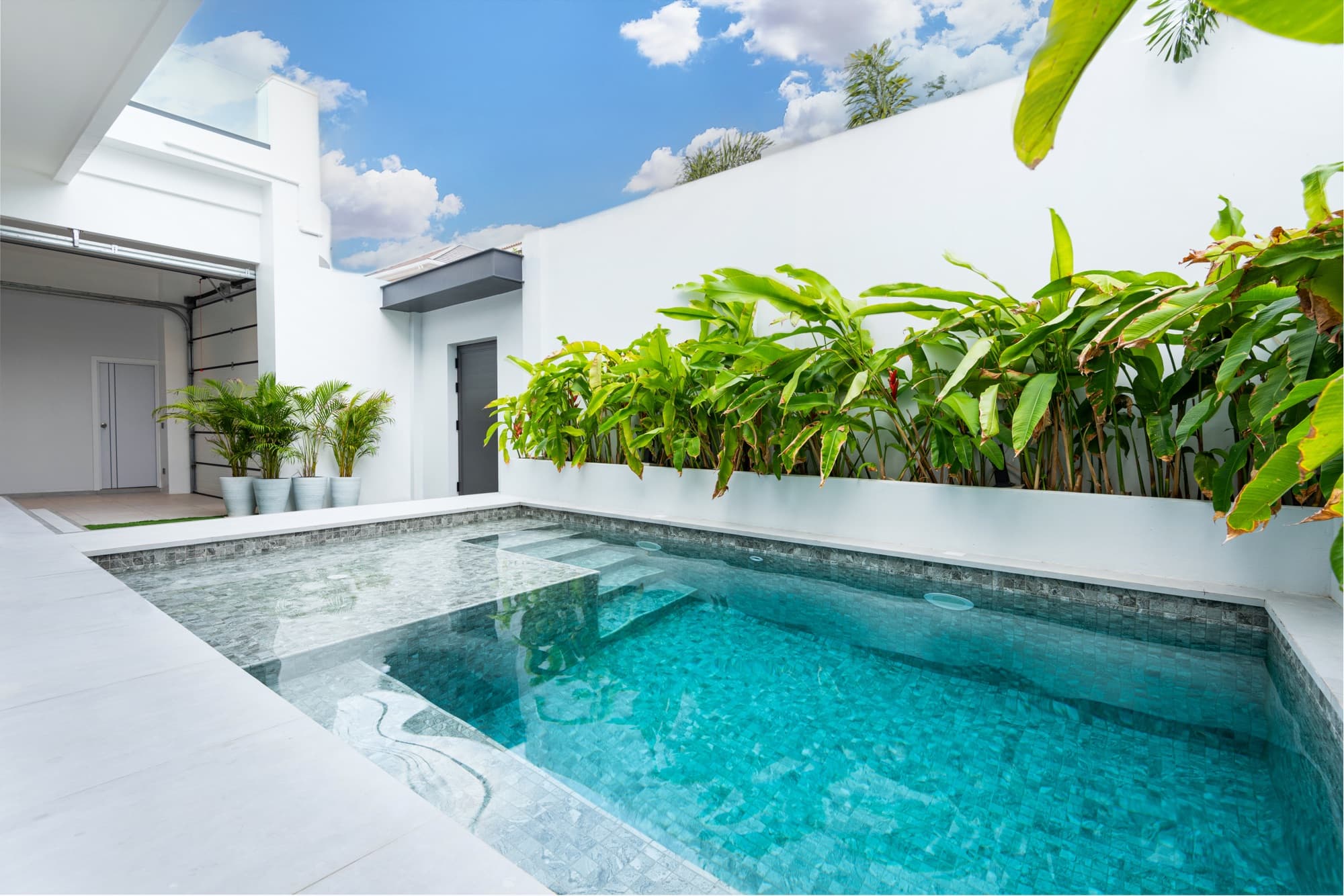 Private saltwater pool inside Villa Azure’s walled compound in Jomtien at dusk — a quiet base five minutes from the Jomtien Beach Road evening strip.